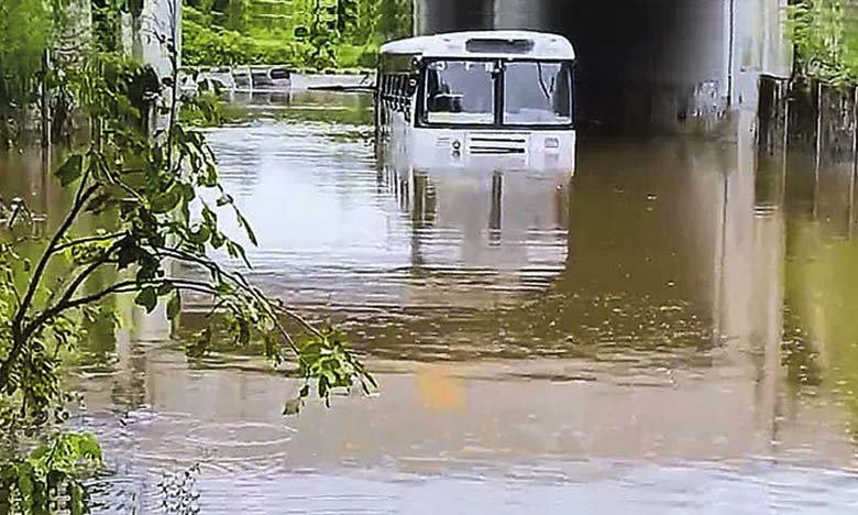 Locals Heroically Rescue Schoolchildren from RTC Bus Stuck in Floodwaters near Shamshabad